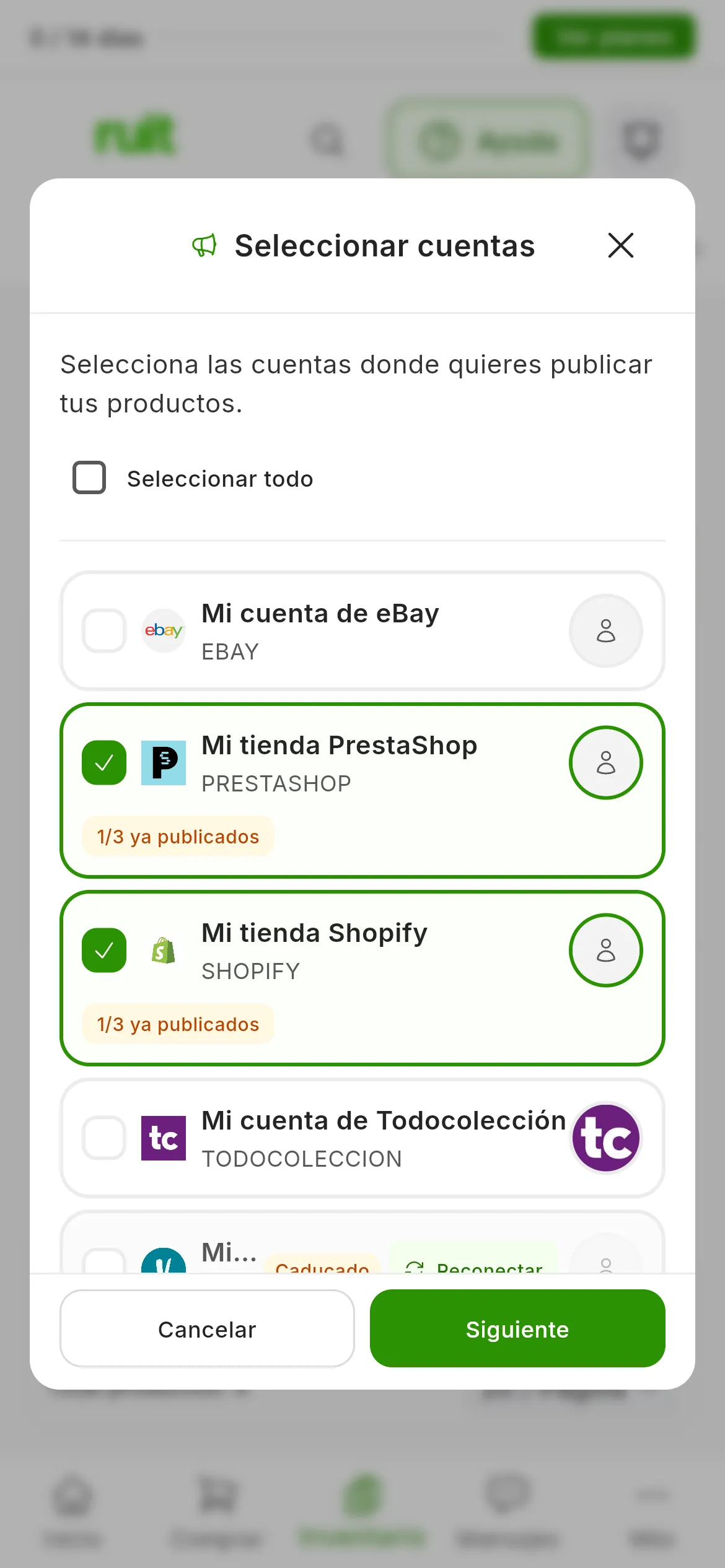 El paso Seleccionar cuentas sobre la tabla difuminada: Mi tienda PrestaShop y Mi tienda Shopify marcadas, cada una con la etiqueta 1/3 ya publicados; Mi cuenta de eBay y Mi cuenta de Todocolección sin marcar, y Mi armario de segunda mano caducado, con Reconectar; abajo, Cancelar y Siguiente